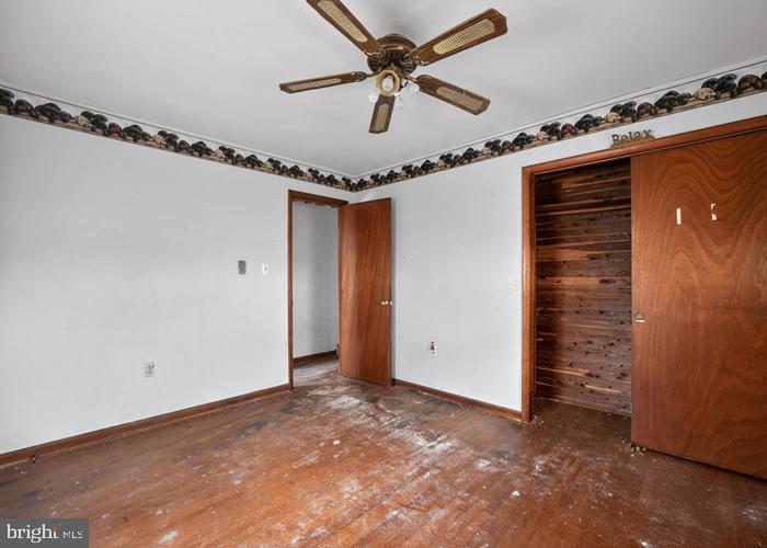 4802 Railroad Avenue Rhodesdale, MD 21659 - Photo 16 of 18 a view of a livingroom with a ceiling fan and wooden floor