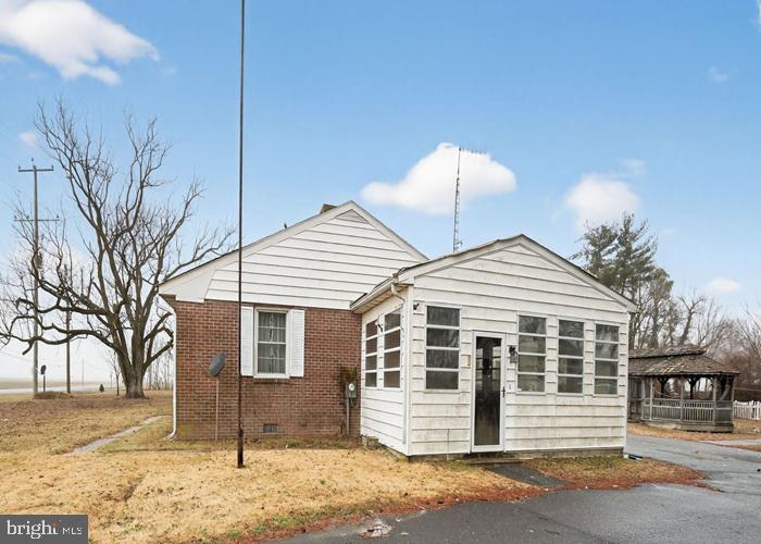4802 Railroad Avenue Rhodesdale, MD 21659 - Photo 2 of 18 a front view of a house with a yard