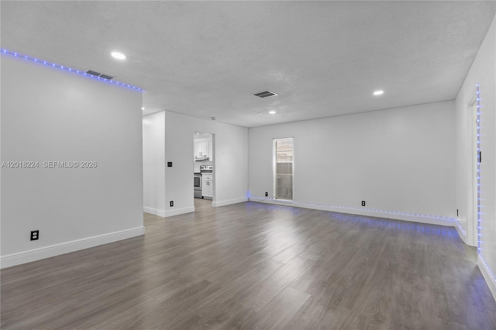 7958 Southwest 6th Street Pompano Beach, FL 33068 - Photo 14 of 57 an empty room with wooden floor and windows