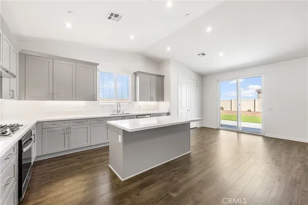 a kitchen with sink cabinets and wooden floor