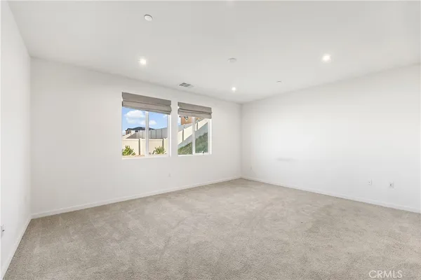 an empty room with closet and a fireplace