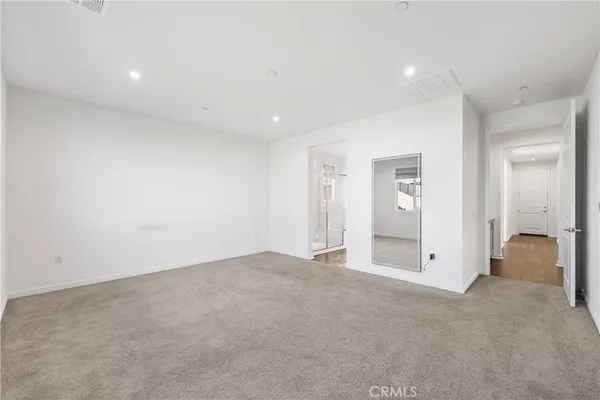 an empty room with closet and a window