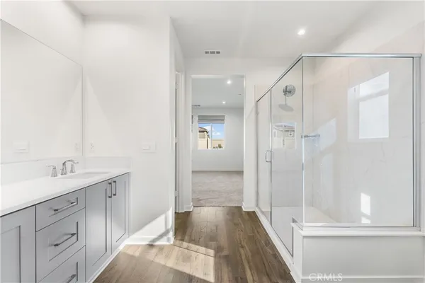 a spacious bathroom with a granite countertop sink mirror and