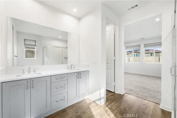 a bathroom with a shower and a glass door