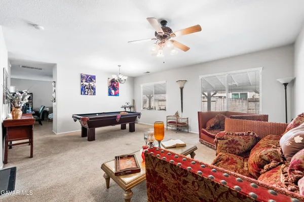 a living room with furniture and a chandelier