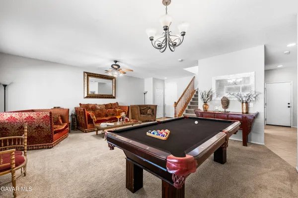 a living room with furniture kitchen view and a dining table