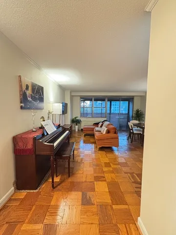 a living room with furniture a rug and a window