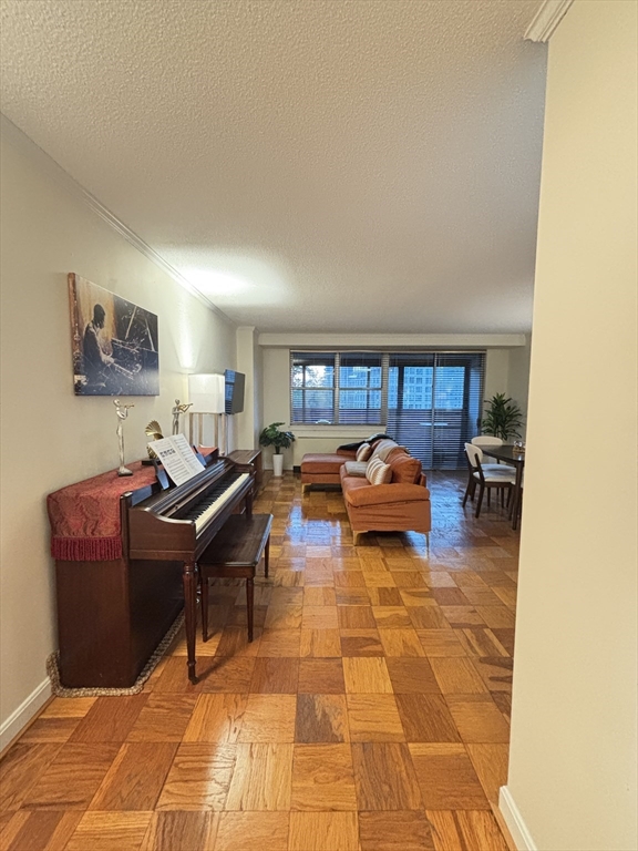 2 Hawthorne Place, Unit 7O Boston, MA 02114 - Photo 4 of 17 a living room with furniture a rug and a window