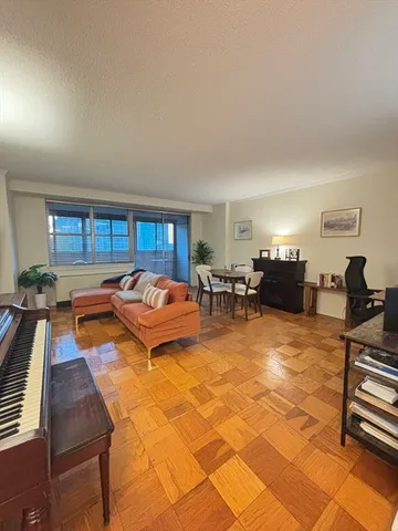 a living room with fireplace furniture and a window