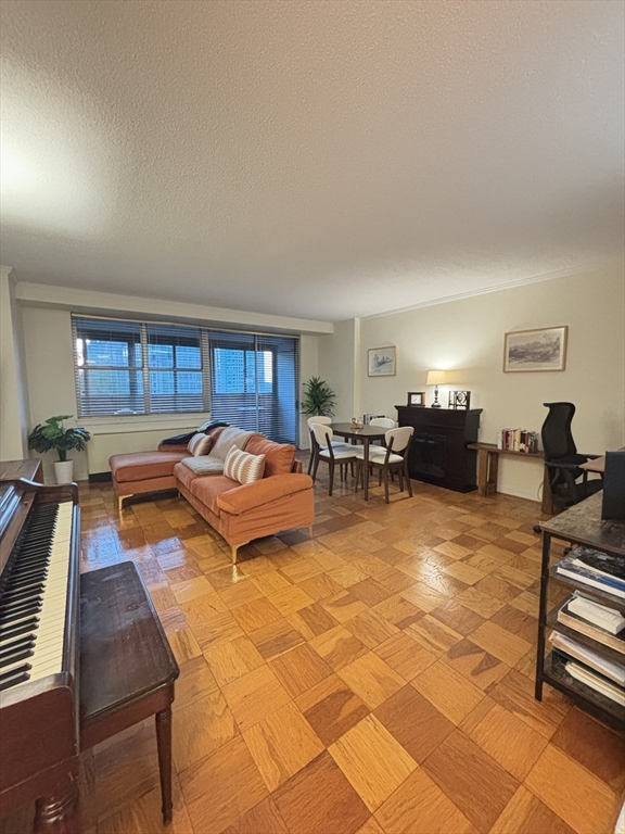 2 Hawthorne Place, Unit 7O Boston, MA 02114 - Photo 5 of 17 a living room with fireplace furniture and a window
