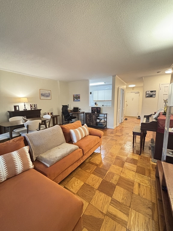 2 Hawthorne Place, Unit 7O Boston, MA 02114 - Photo 6 of 17 a living room with furniture and a dining table with kitchen view