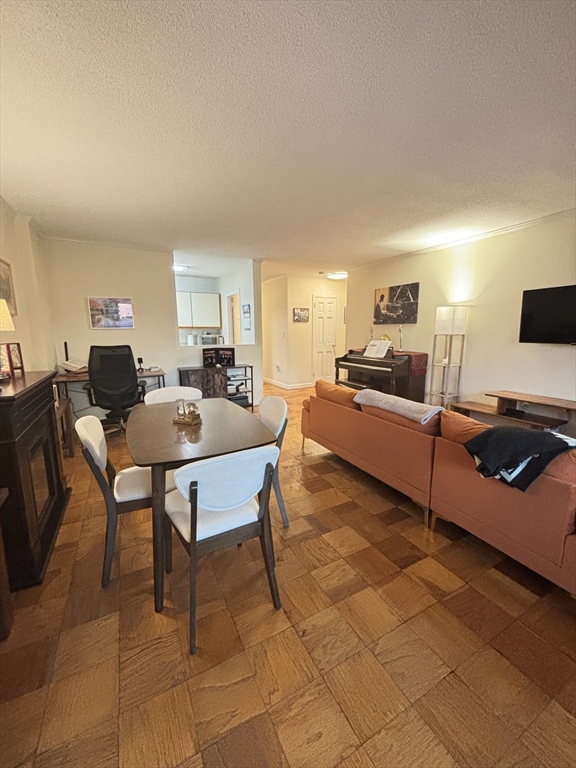 2 Hawthorne Place, Unit 7O Boston, MA 02114 - Photo 7 of 17 a living room with furniture a flat screen tv and a table