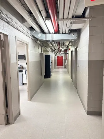 a view of hallway with a refrigerator