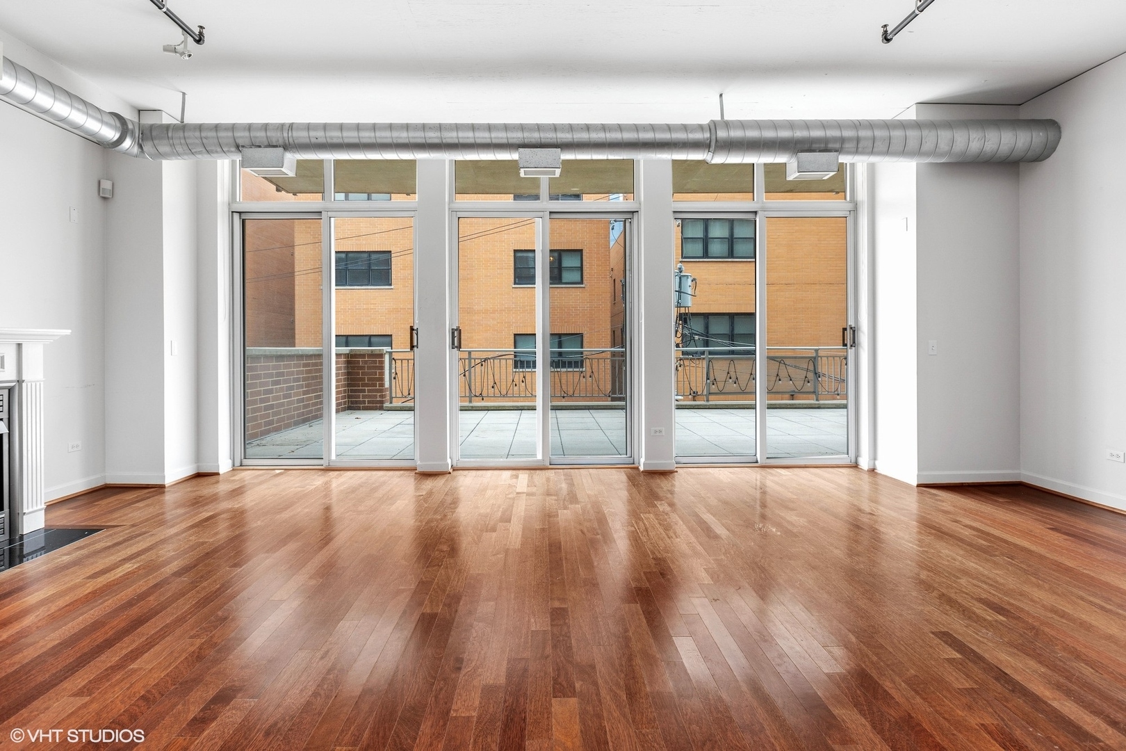 111 South Morgan Street, Unit 325 Chicago, IL 60607 - Photo 2 of 18 a view of an empty room with wooden floor and a window