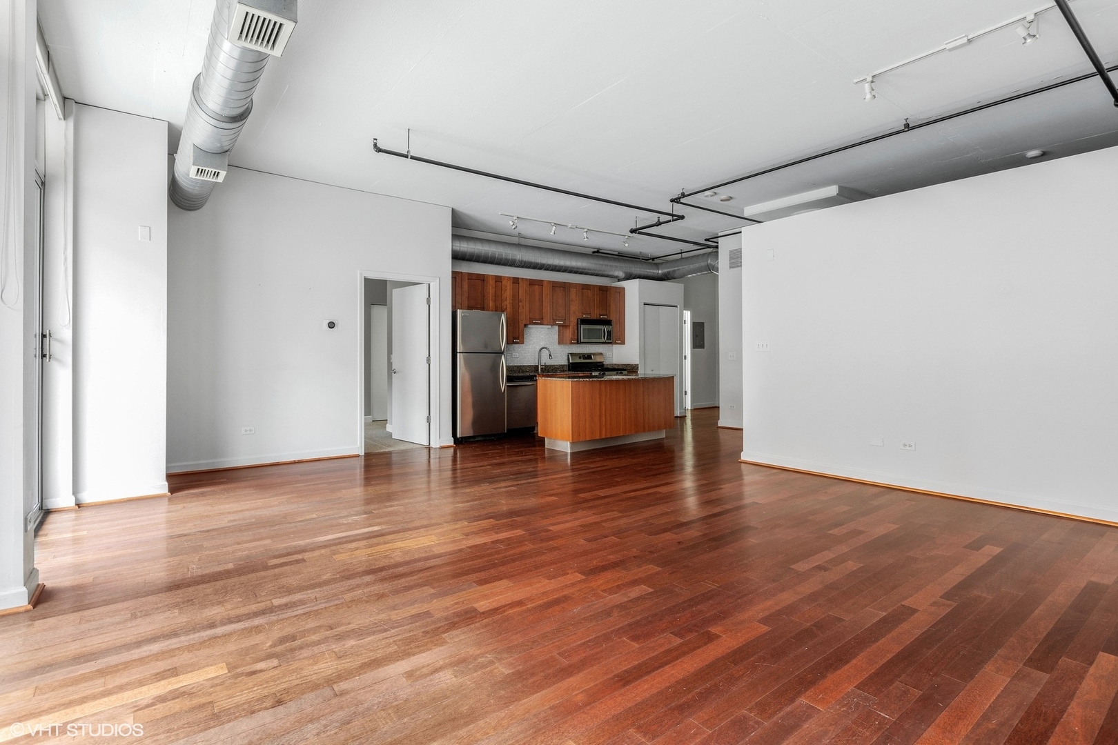 111 South Morgan Street, Unit 325 Chicago, IL 60607 - Photo 5 of 18 a view of a room with wooden floor and appliances