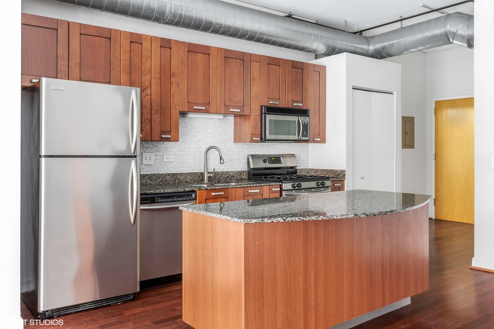 111 South Morgan Street, Unit 325 Chicago, IL 60607 - Photo 6 of 18 a kitchen with stainless steel appliances granite countertop a refrigerator a stove a sink and a granite counter tops with wooden floors