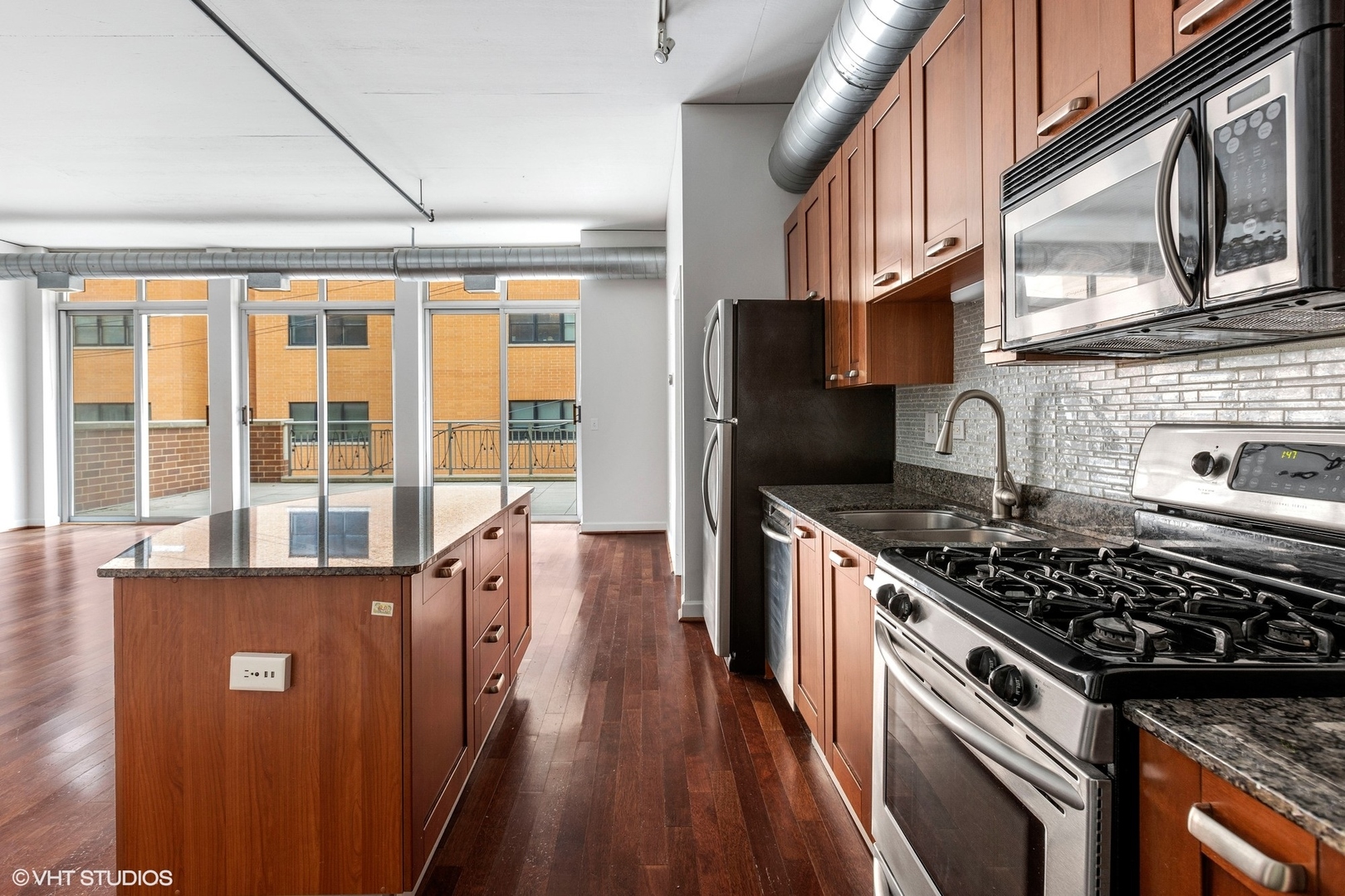 111 South Morgan Street, Unit 325 Chicago, IL 60607 - Photo 8 of 18 a kitchen with stainless steel appliances granite countertop a stove and a sink