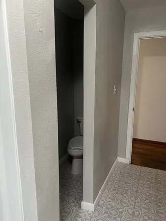 a view of a bathroom from a hallway