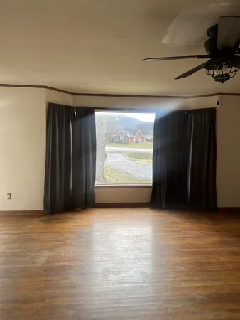 a view of an empty room with a window