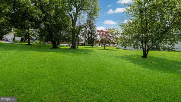 a view of field with trees in the background