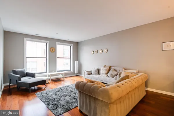 a living room with furniture and a rug