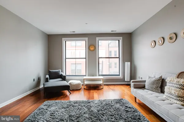 a living room with furniture and a rug