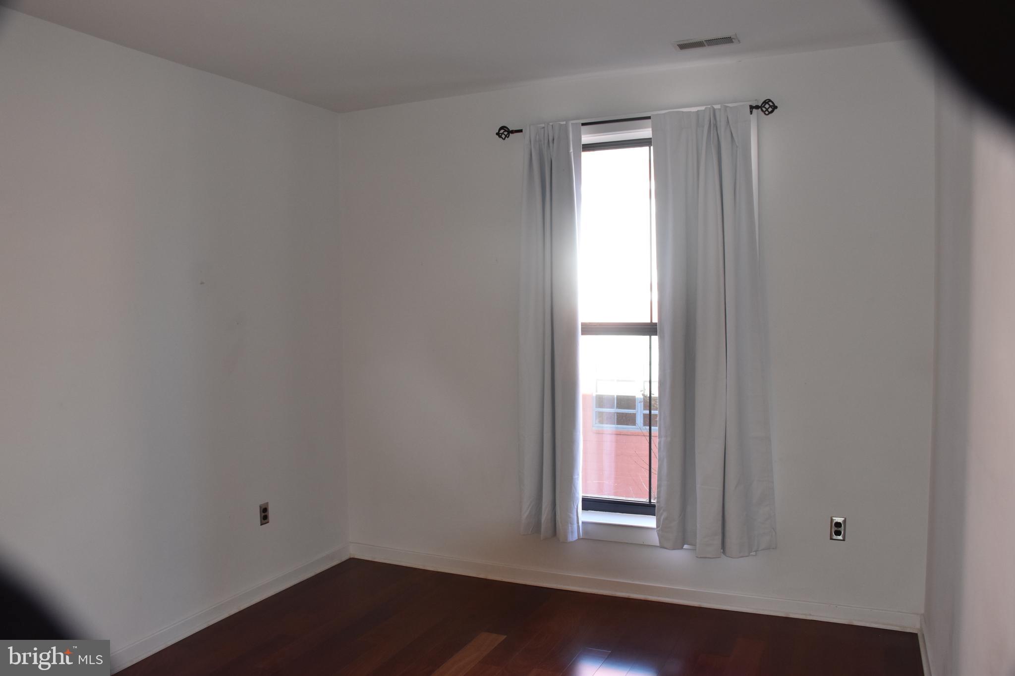 2007 Clipper Park Road, Unit 212 Baltimore, MD 21211 - Photo 18 of 33 a view of empty room with wooden floor and fan