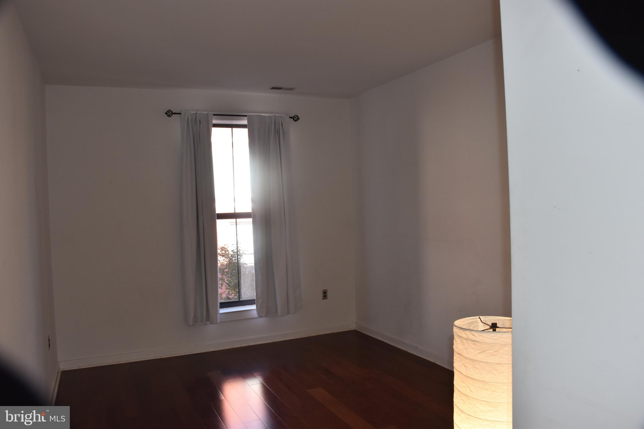 2007 Clipper Park Road, Unit 212 Baltimore, MD 21211 - Photo 19 of 33 a view of empty room with wooden floor and fan