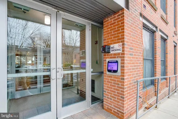 a view of a brick building with a door and a porch