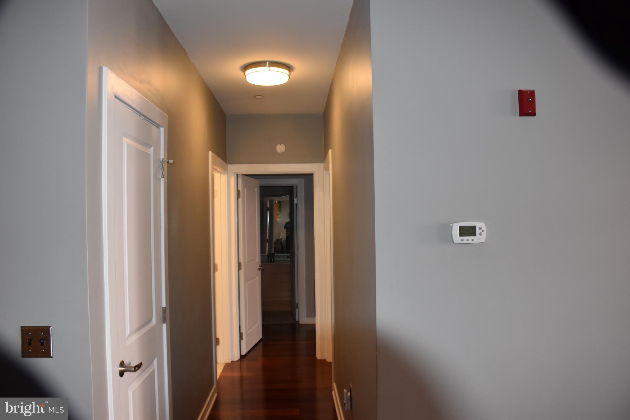 2007 Clipper Park Road, Unit 212 Baltimore, MD 21211 - Photo 23 of 33 a view of a hallway with wooden floor