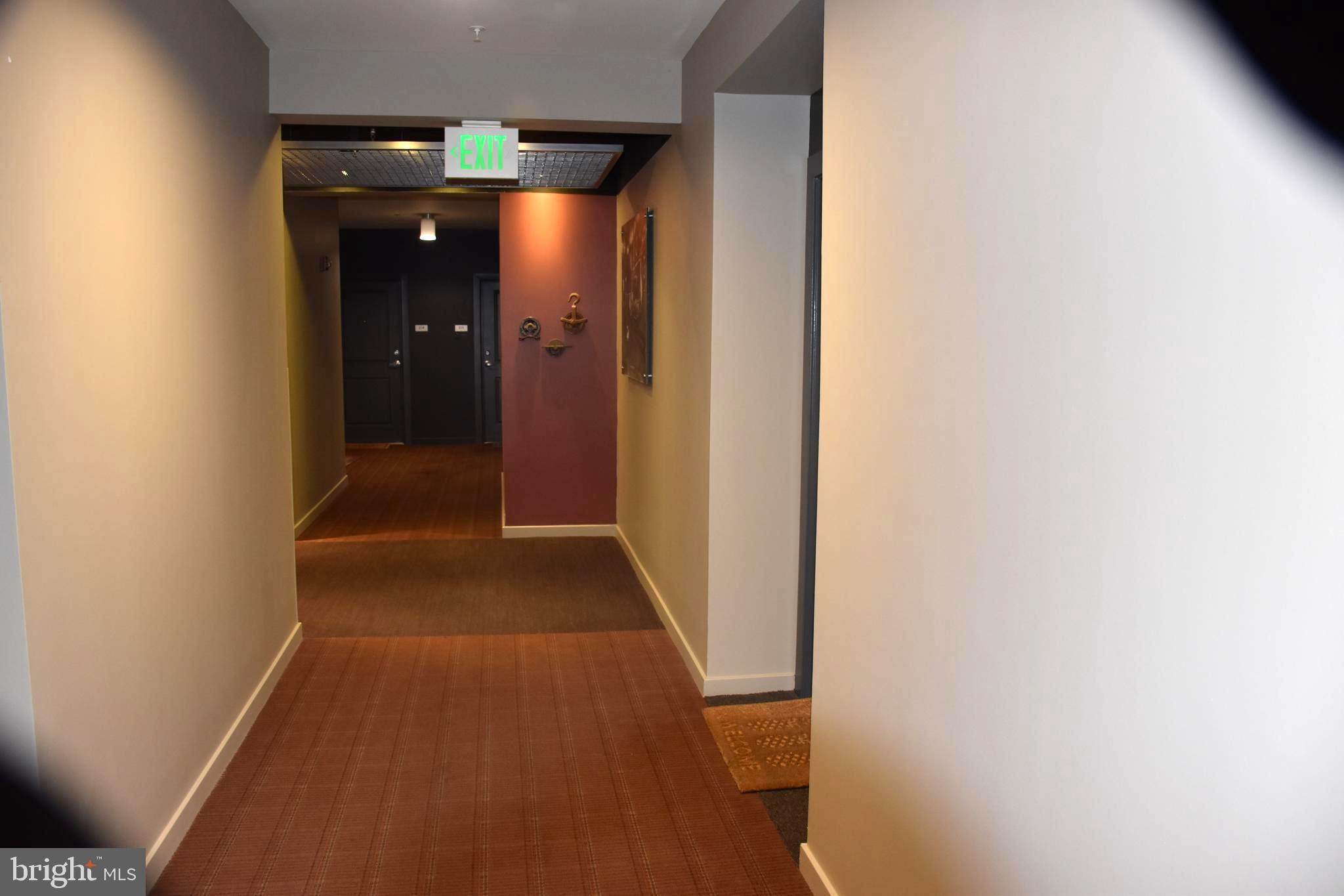 2007 Clipper Park Road, Unit 212 Baltimore, MD 21211 - Photo 28 of 33 a view of a hallway with wooden shelves