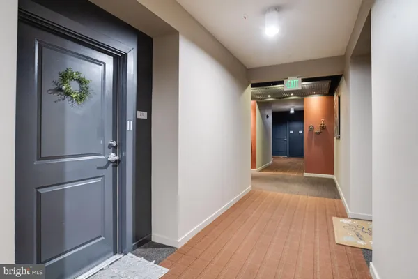 a view of hallway with wooden floor
