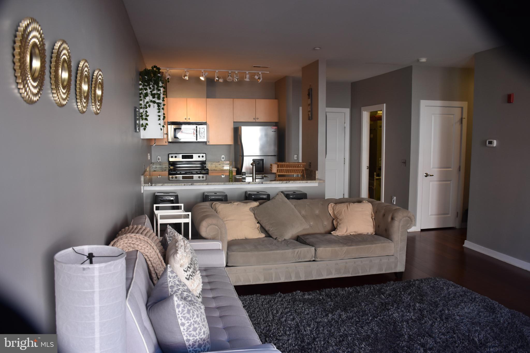 2007 Clipper Park Road, Unit 212 Baltimore, MD 21211 - Photo 5 of 33 a living room with furniture and a wooden floor