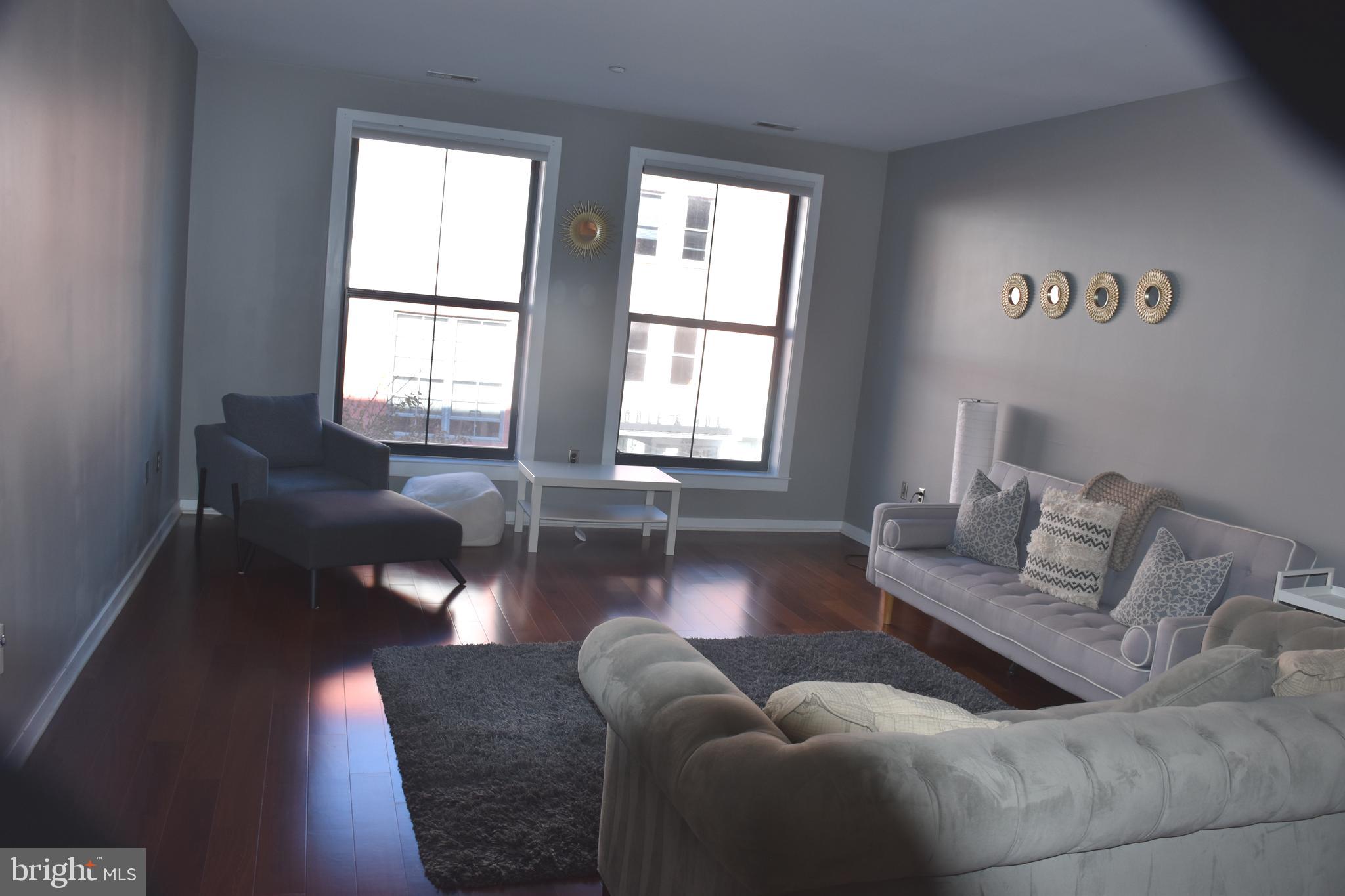 2007 Clipper Park Road, Unit 212 Baltimore, MD 21211 - Photo 6 of 33 a living room with furniture and a large window