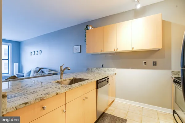 a kitchen with a sink cabinets and a window
