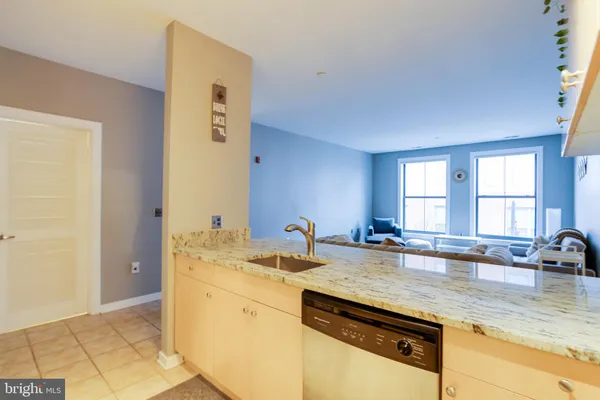 a kitchen with a sink a stove and cabinets