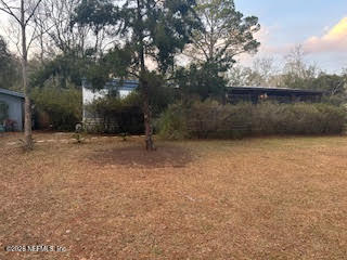 374394 Kings Ferry Road Hilliard, FL 32046 - Photo 1 of 2 a backyard of a house with lots of green space