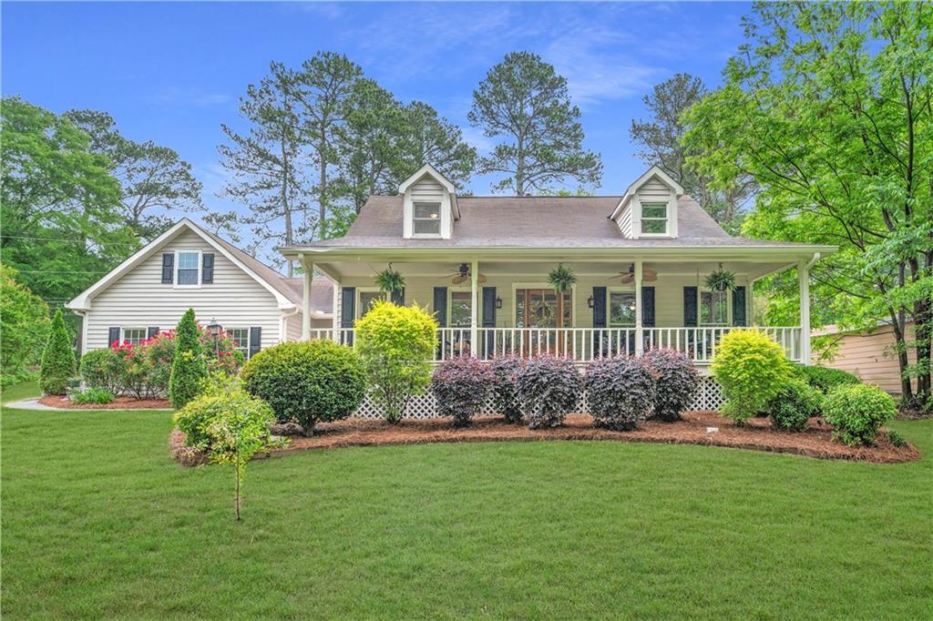 1870 Shoreline Trace Southwest Grayson, GA 30017 - Photo 1 of 1 a front view of a house with garden