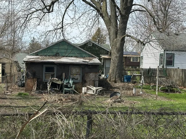 a view of house with backyard and seating area