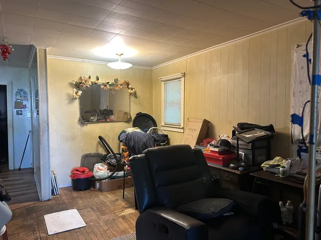 a living room with furniture a lamp and a window