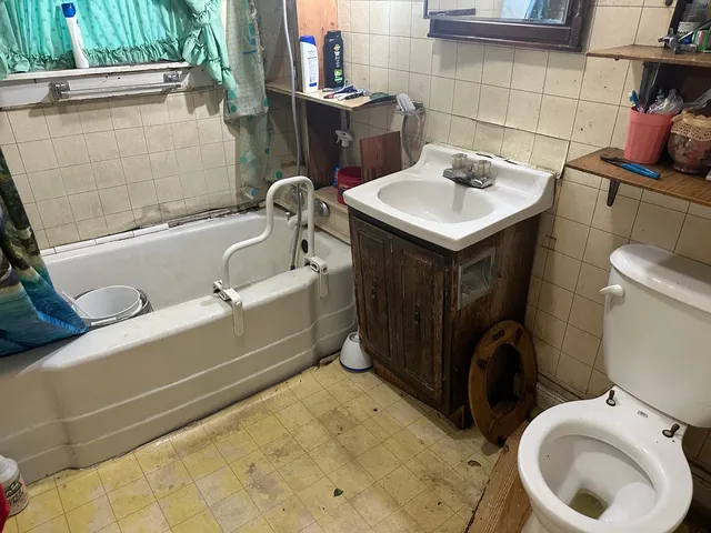 a bathroom with a sink toilet and tub