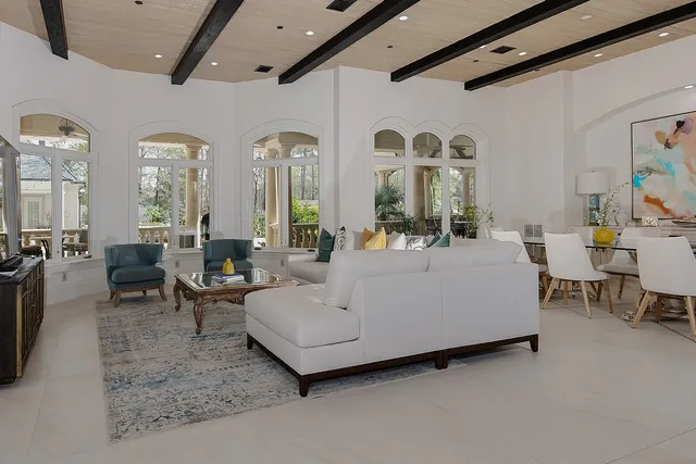 a living room with furniture and a large mirror