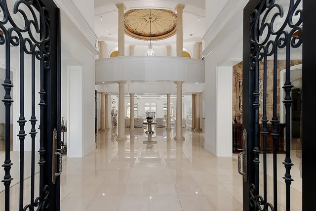 a view of a hallway with dining area and chandelier