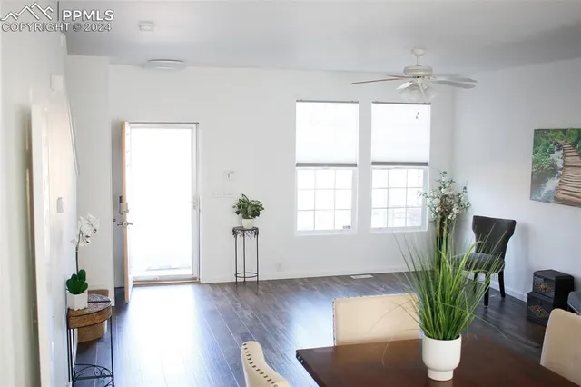 a view of a hallway with wooden floor and entryway