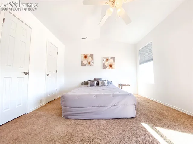 a view of a bedroom with window and hallway