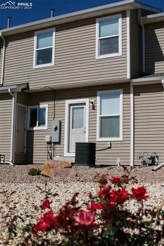a kitchen with stainless steel appliances wooden floor and wooden cabinets