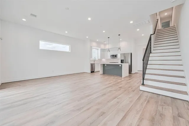 a view of kitchen with wooden floor and electronic appliances