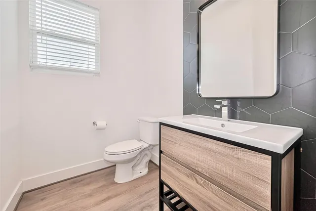 a bathroom with a sink toilet and a mirror