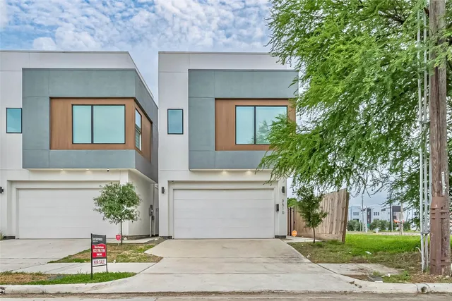 a view of a house with a yard and garage