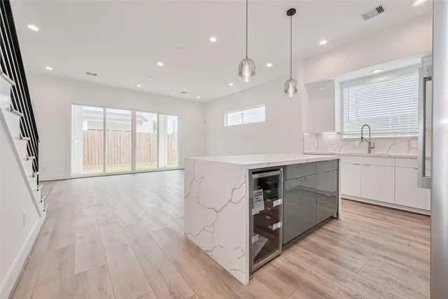a kitchen with a stove a sink and a refrigerator